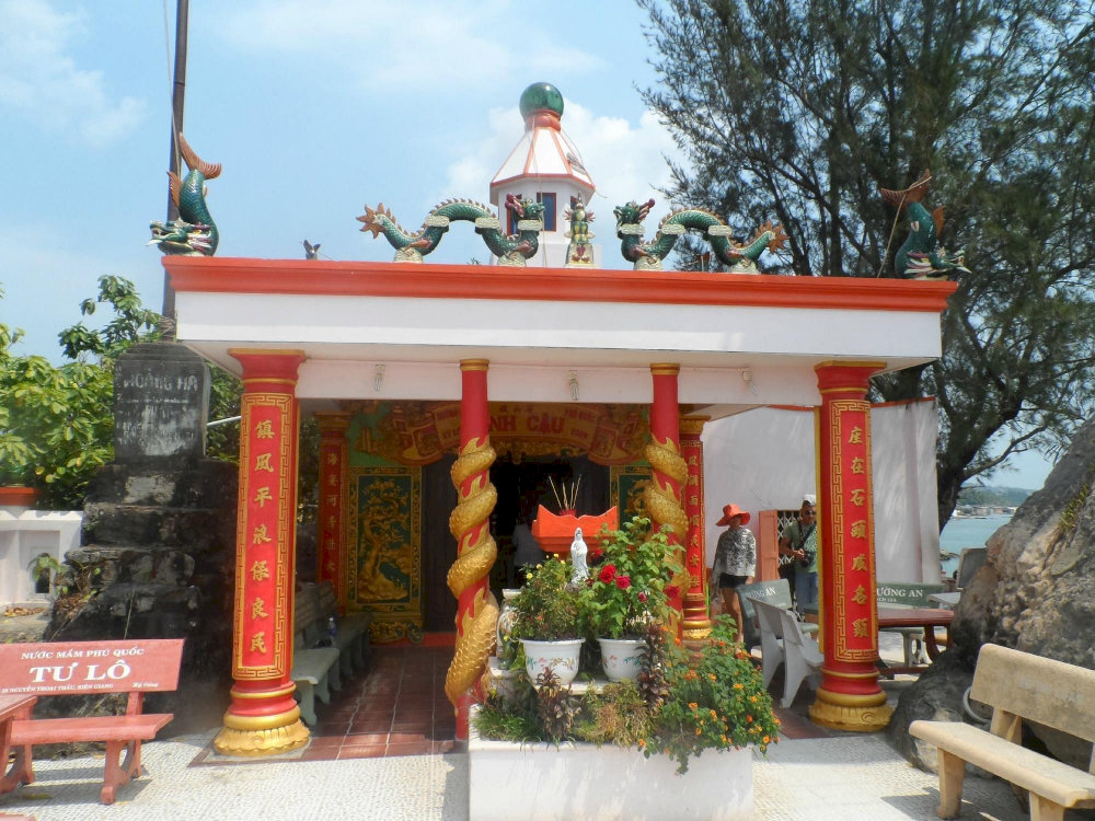 Dinh Cau Temple stands gracefully on a rocky promontory overlooking the sea, blending spiritual reverence with scenic beauty